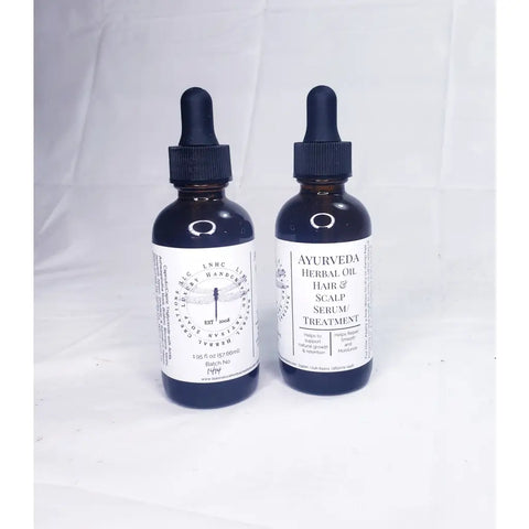 Two dark glass bottles of herbal hair and scalp treatment products with dropper caps.