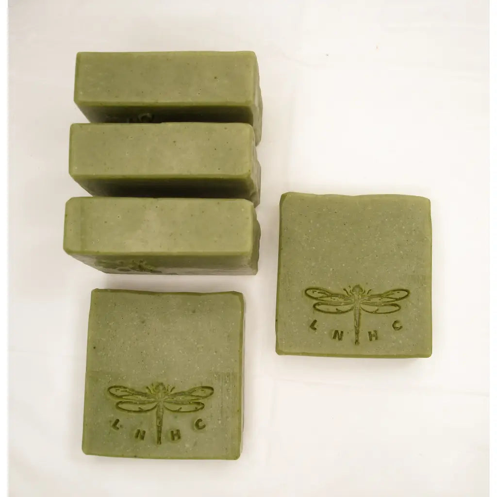 Green soap bars with a dragonfly logo stamped on some of them.