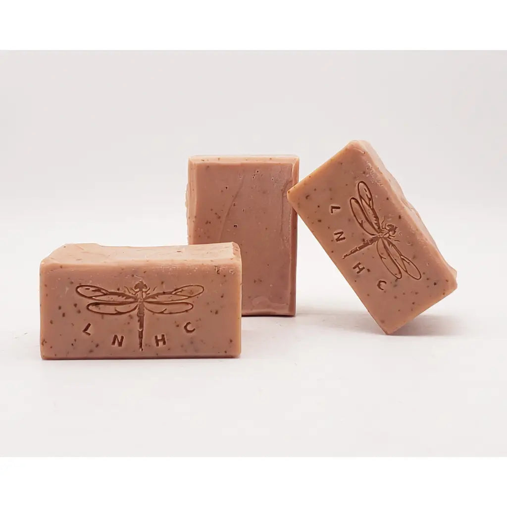 Pink handmade soap bars with dragonfly imprints.