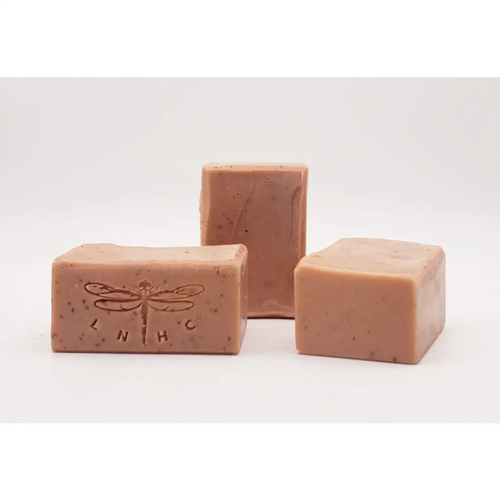 Pink handmade soap bars with dragonfly imprints.