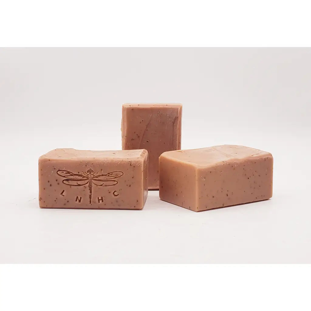 Pink handmade soap bars with dragonfly imprints.