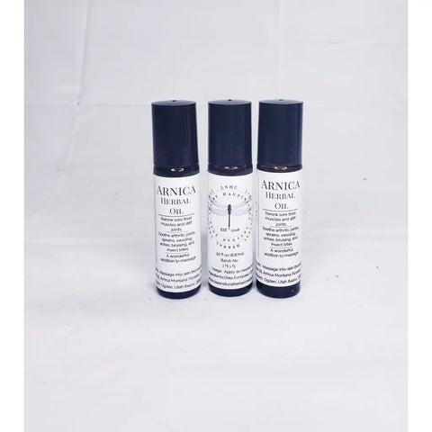 Three bottles of Arnica herbal oil with dropper caps.