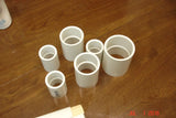 Assortment of white PVC pipe couplings for Pipe Swirl Soap Challenge slab mold