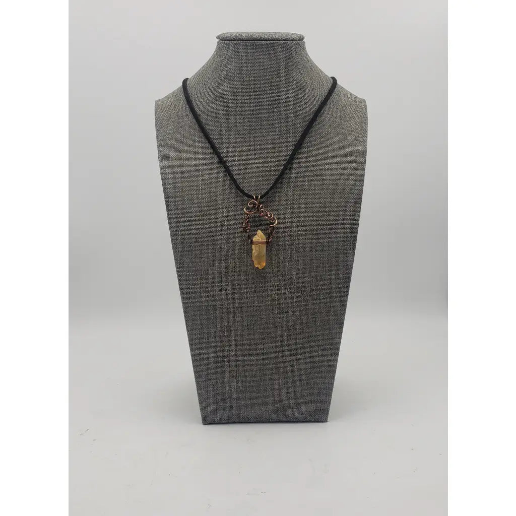 Crystal pendant necklace with intricate wire wrapping and a black cord.