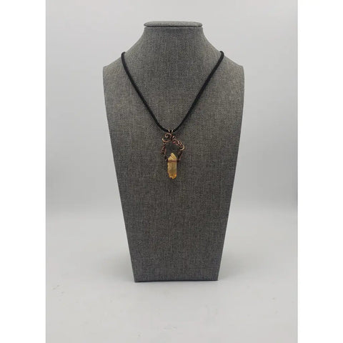 Crystal pendant necklace with intricate wire wrapping and a black cord.