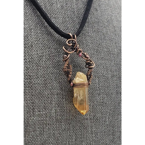 Crystal pendant necklace with intricate wire wrapping and a black cord.