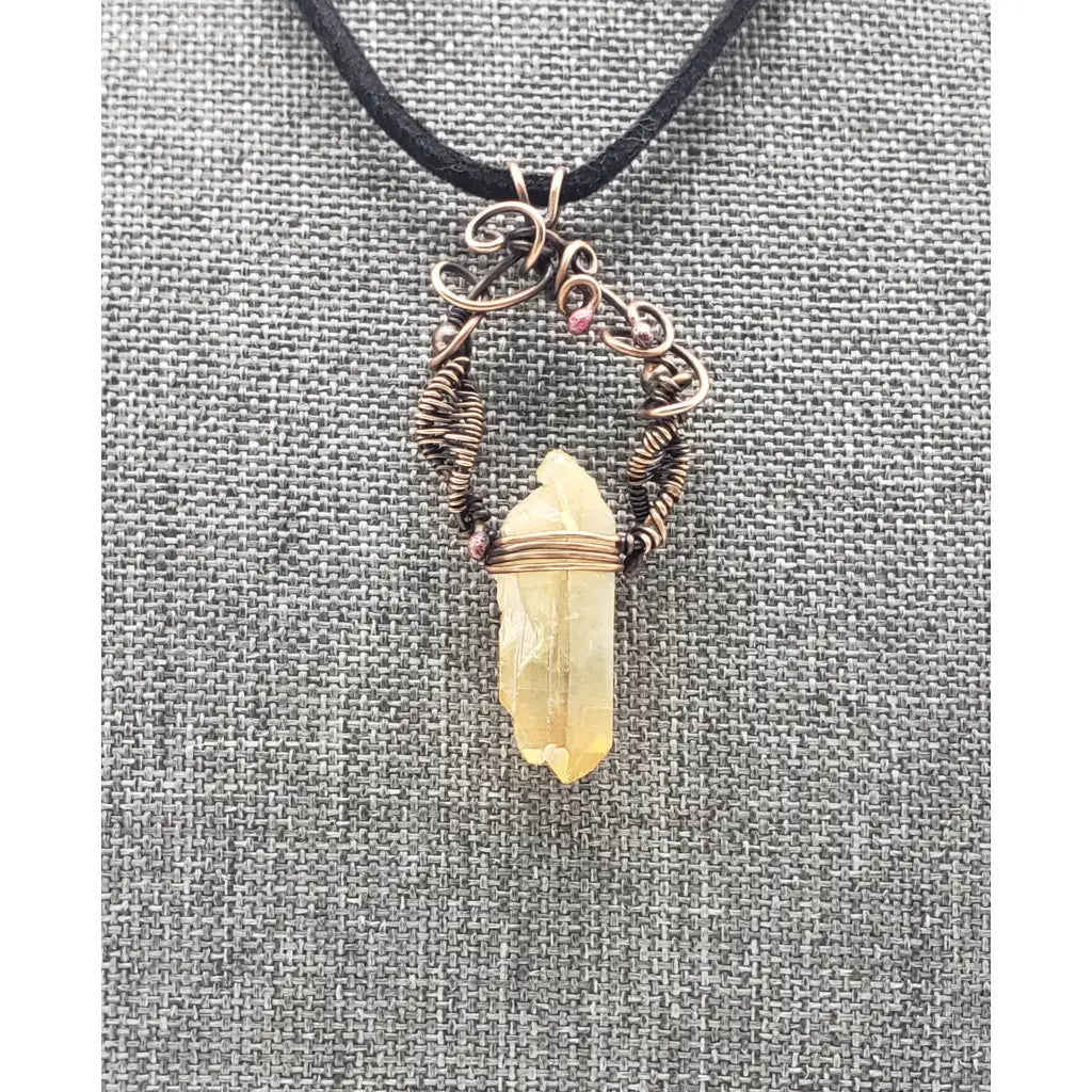 Crystal pendant necklace with intricate wire wrapping and a black cord.