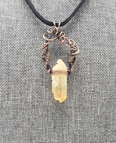 Crystal pendant necklace with intricate wire wrapping and a black cord.
