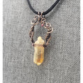 Crystal pendant necklace with intricate wire wrapping and a black cord.