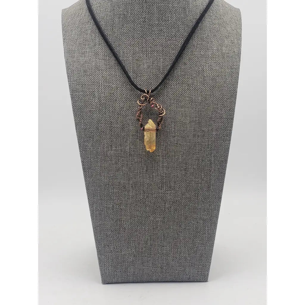 Crystal pendant necklace with intricate wire wrapping and a black cord.
