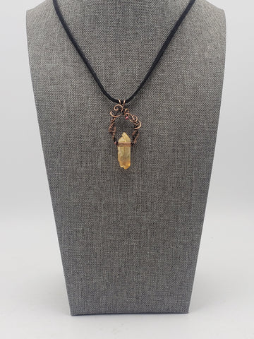 Crystal pendant necklace with intricate wire wrapping and a black cord.