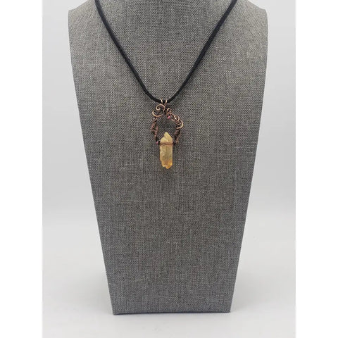 Crystal pendant necklace with intricate wire wrapping and a black cord.