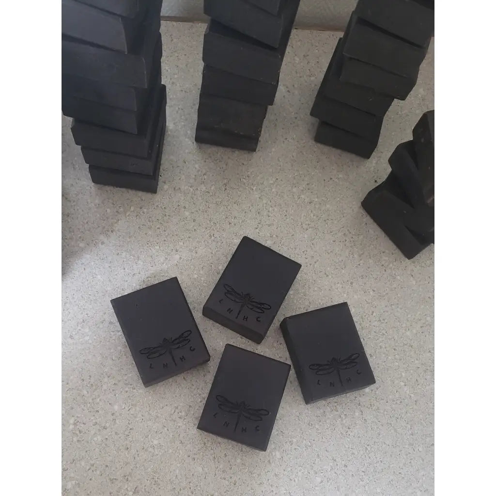 Black rectangular blocks with a dragonfly logo engraved on them.