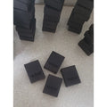 Black rectangular blocks with a dragonfly logo engraved on them.