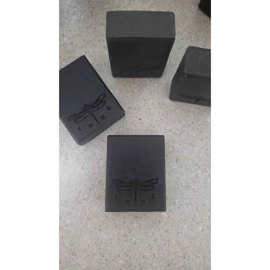 Black rectangular blocks with a dragonfly logo engraved on them.