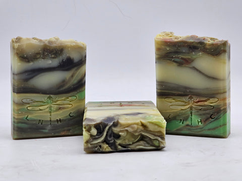 Handmade artisanal soap bars with swirled patterns and dragonfly designs.