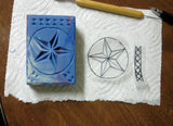 Blue rectangular carved soap with a five-point star design using wood chip carving