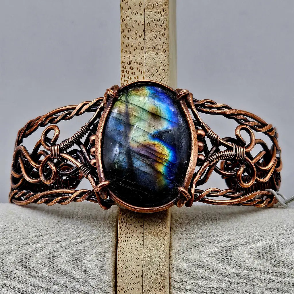 Copper wire wrapped cuff bracelet with a large labradorite cabachon with flashy labradorescence. celtic braided style copper work