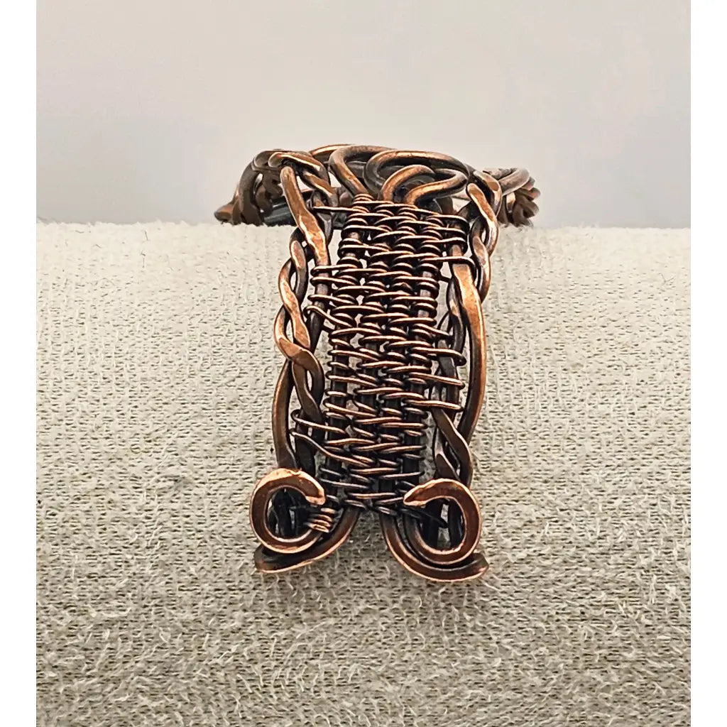 copper wire wrapping work on a cuff bracelet