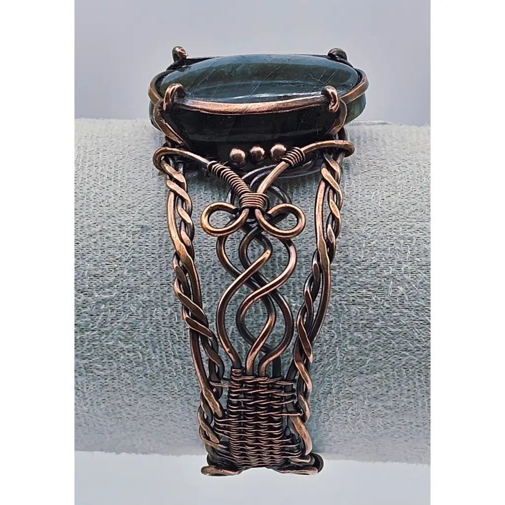 Copper wire wrapped cuff bracelet with a large labradorite cabachon with flashy labradorescence. celtic braided style copper work