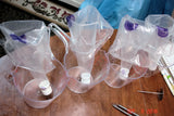 Clear plastic cups with white items inside for soap challenge featuring oatmeal milk and shea butter