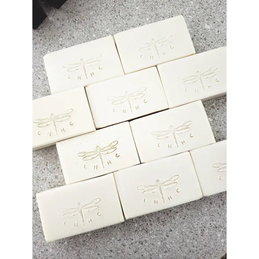 White soap bars with embossed dragonfly designs 
