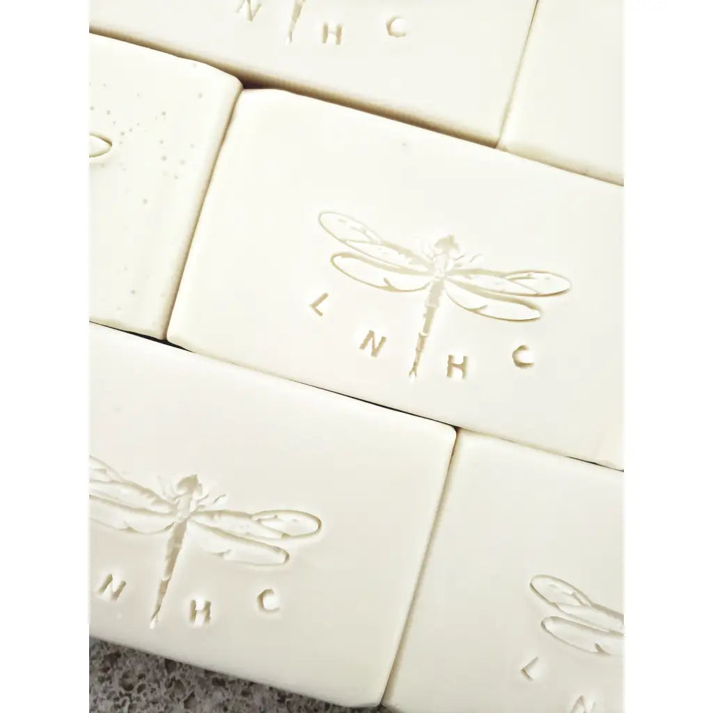 White soap bars with embossed dragonfly designs 