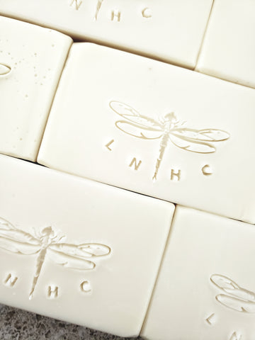 White soap bars with embossed dragonfly designs 