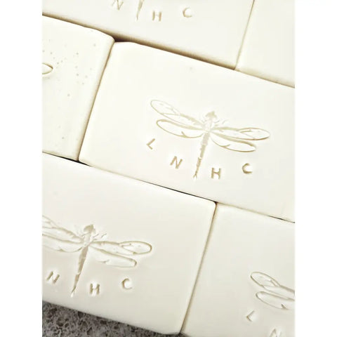 White soap bars with embossed dragonfly designs 