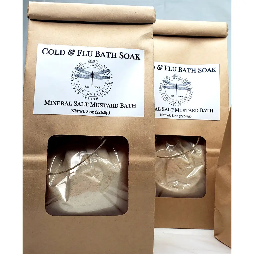 Cold & flu bath soak products in kraft paper packaging with mineral salt and mustard bath ingredients.