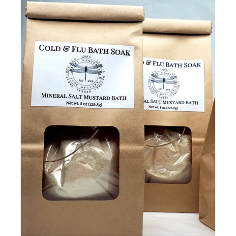 Cold & flu bath soak products in kraft paper packaging with mineral salt and mustard bath ingredients.