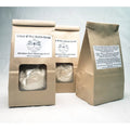 Cold & flu bath soak products in kraft paper packaging with mineral salt and mustard bath ingredients.