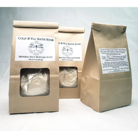 Cold & flu bath soak products in kraft paper packaging with mineral salt and mustard bath ingredients.
