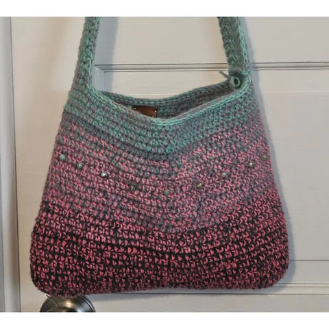 Crocheted shoulder bag with an ombre effect from mint green to pink.