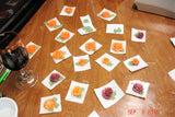Decorative fruit-shaped candies on white squares for soap challenge featuring oatmeal milk and shea butter
