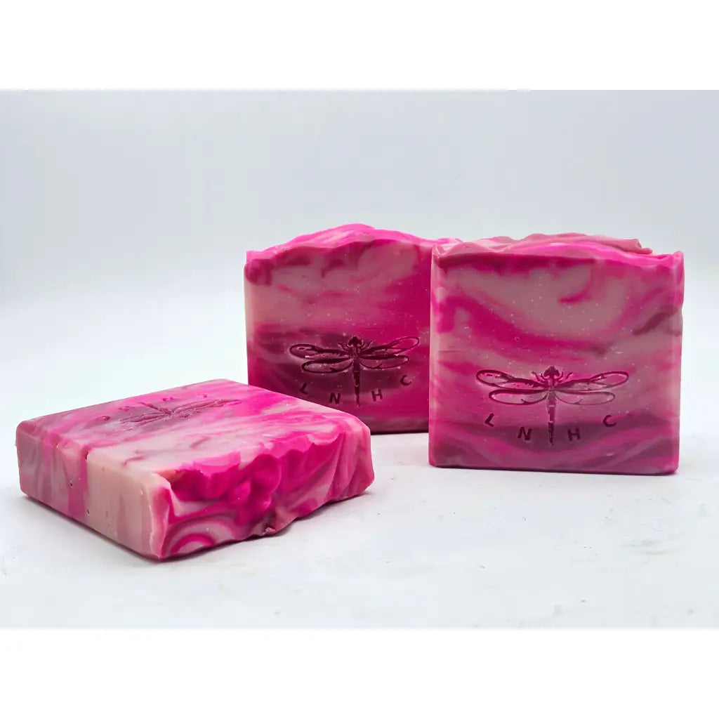 Pink marbled soap bars with dragonfly imprints.