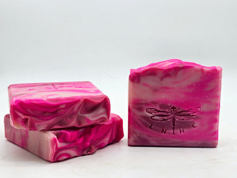 Pink marbled soap bars with dragonfly imprints.