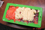 Green plastic tray with colorful modeling clay for soap challenge in oatmeal milk and shea butter recipe