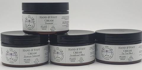 Hand and foot cream containers with minimalist black and white labels.