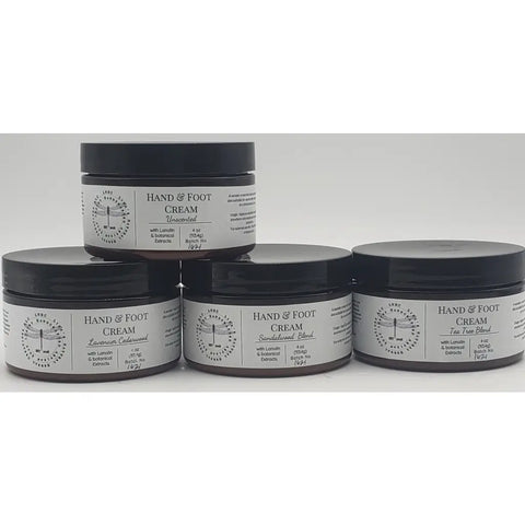 Hand and foot cream containers with minimalist black and white labels.