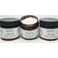 Jars of handcrafted arnica cream with black lids and labels.