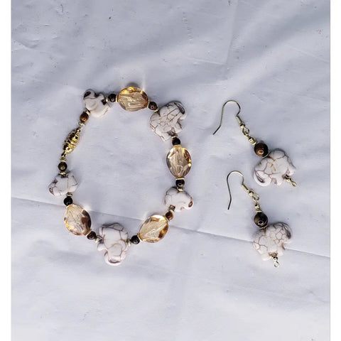 Handcrafted jewelry set featuring white elephant-shaped beads and amber-colored crystal accents.