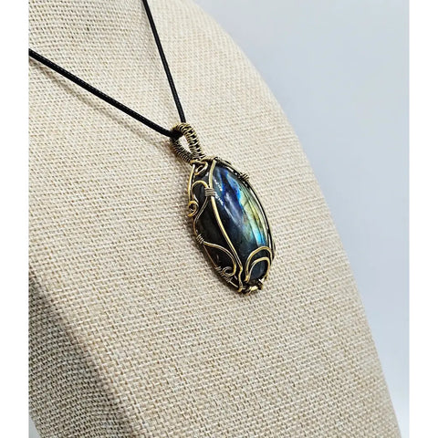 Handcrafted labradorite pendant with gold wire wrapping and iridescent oval stone