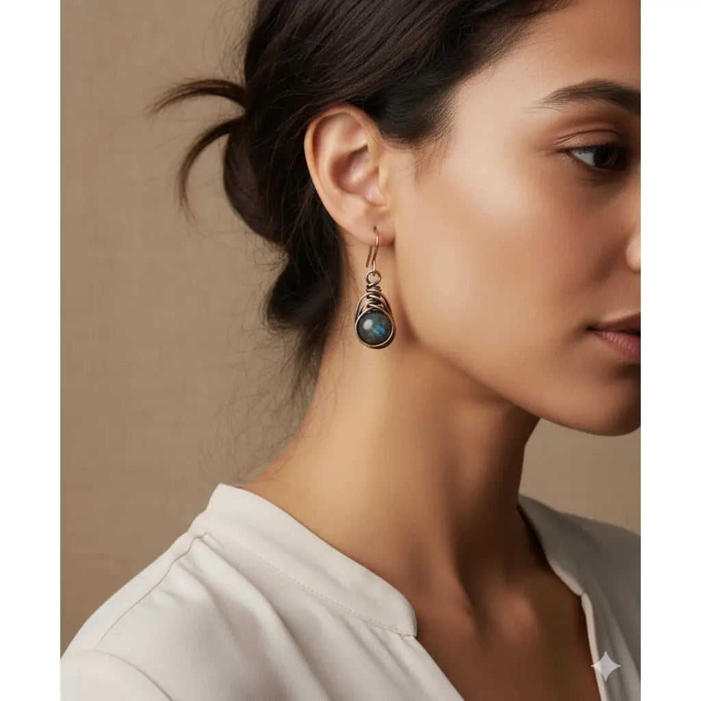 A woman wearing Wire-Wrapped herringbone earrings with impression jasper gemstone beads in copper