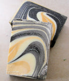 Marbled black, white, and orange soap bars from Great Cakes Soap Challenge featuring a unique soap recipe