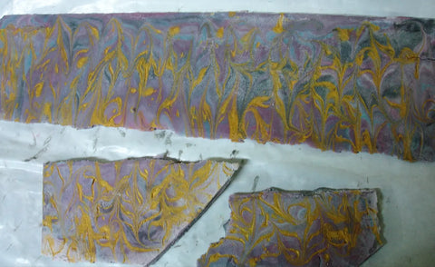 Marbled purple gray and gold soap bars showcasing advanced rimmed soap technique