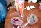 Colorful liquids in plastic bags for soap challenge featuring oatmeal milk and shea butter