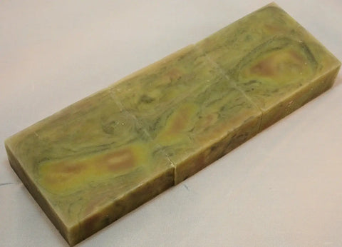 Marbled green and yellow soap bar showcasing wood grain technique for Lisas Natural soap challenge