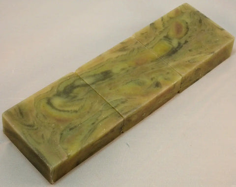 Swirled green and yellow marbled soap bar showcasing the wood grain technique for Lisas Natural soap challenge