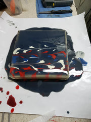 Lapis blue acrylic string pull soap with streaks of red white and lighter blue